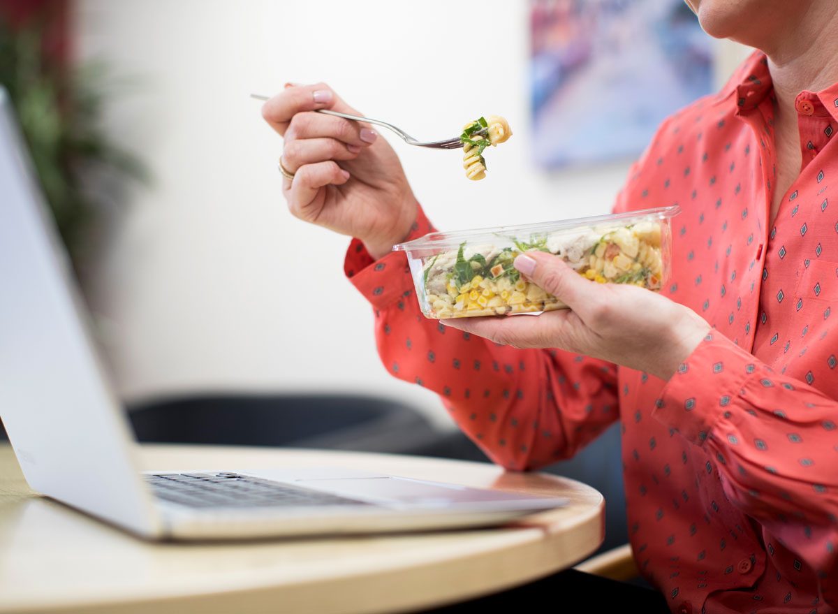 woman eating lunch at desk